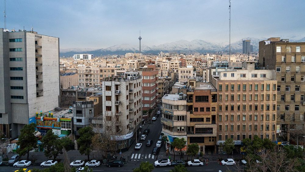 Wide view of Tehran with Milad Tower and snowy peaks