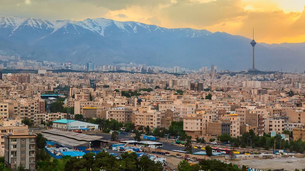 Beautiful cityscape sunset panorama of Tehran city, mountains and Milad tower in during colorful sunset in Iran
