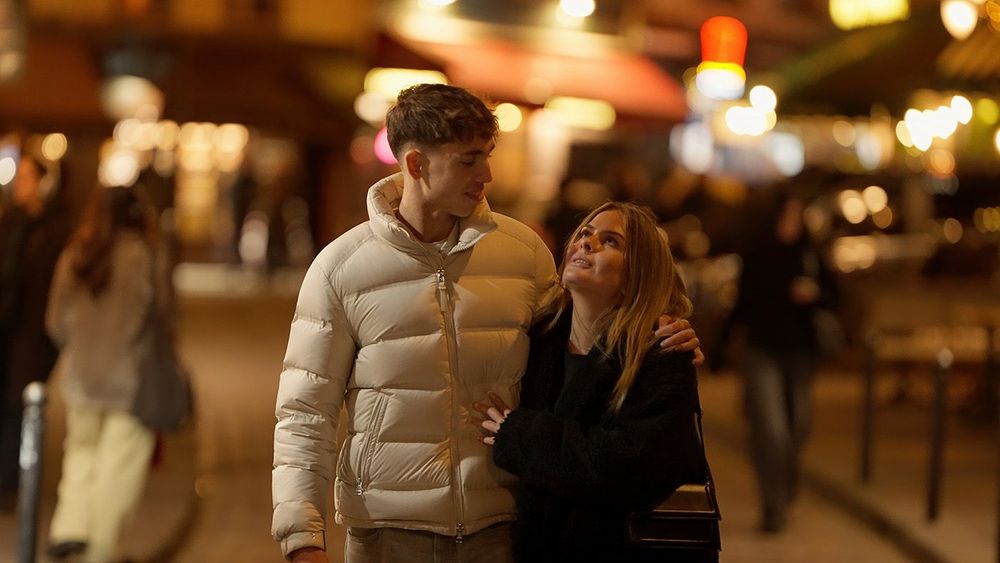 Romantic Couple Walking Together In Paris France At Night With City Lights And Urban Street Background Love And Affection In European