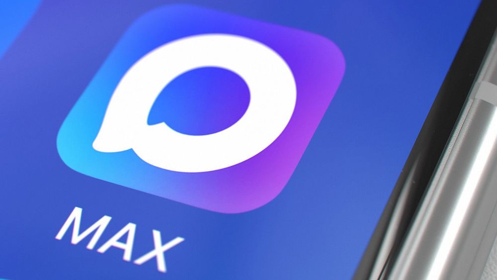 A close-up of the Russian messenger MAX icon on the screen of a silver smartphone on a white table. Mobile technology. Kazakhstan, Astana - September 3, 2025
