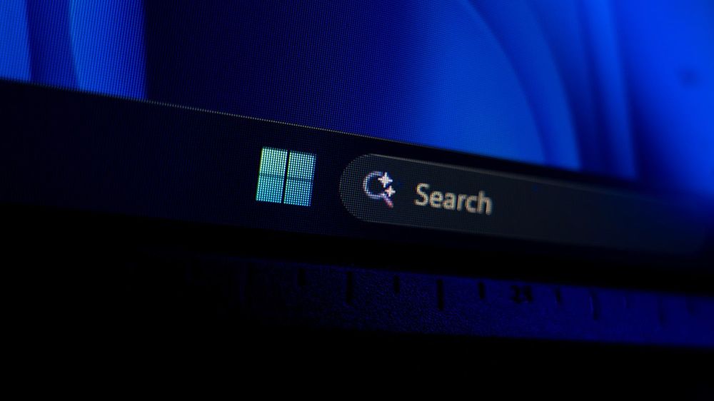 Windows 11 taskbar showing the Start button and search bar against a dark blue background, modern desktop operating system navigation and user interface concept