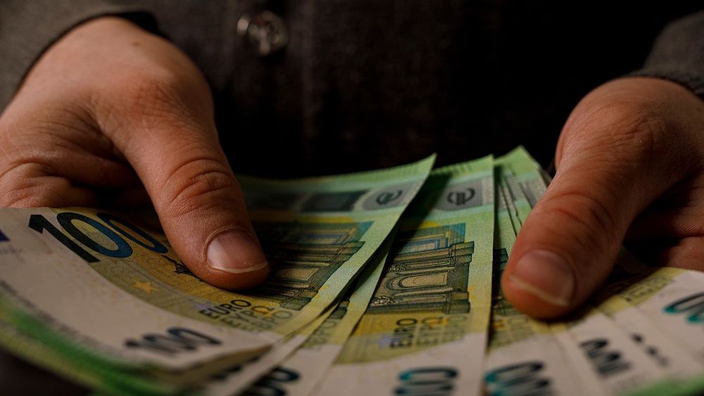 Close-up of hands holding euro banknotes. Money, finance, wealth