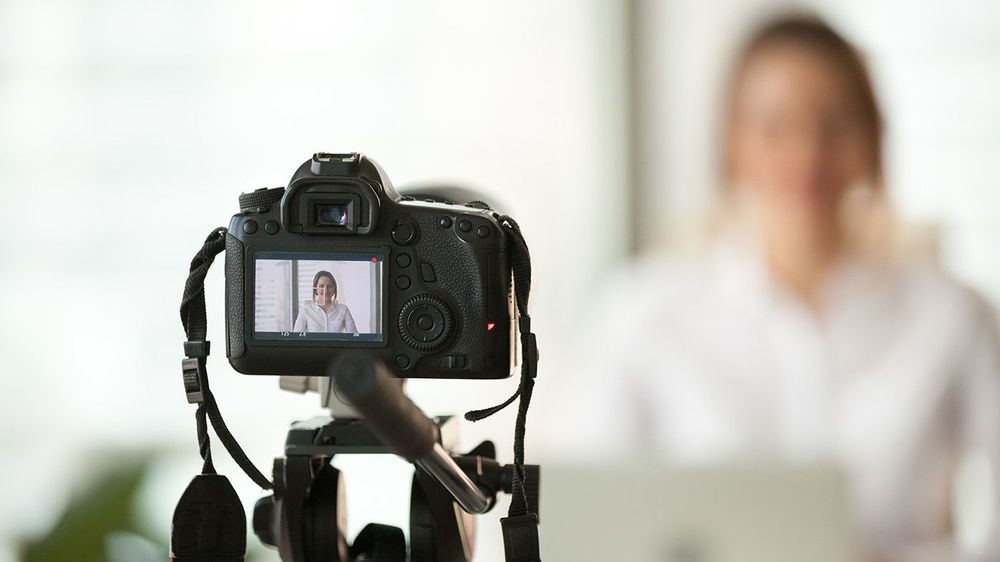 Professional dslr digital camera filming vlog of business woman