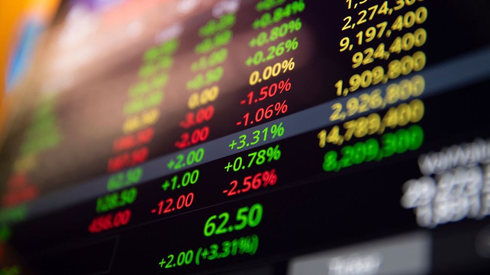 close-up stock market screen showing Tiker running