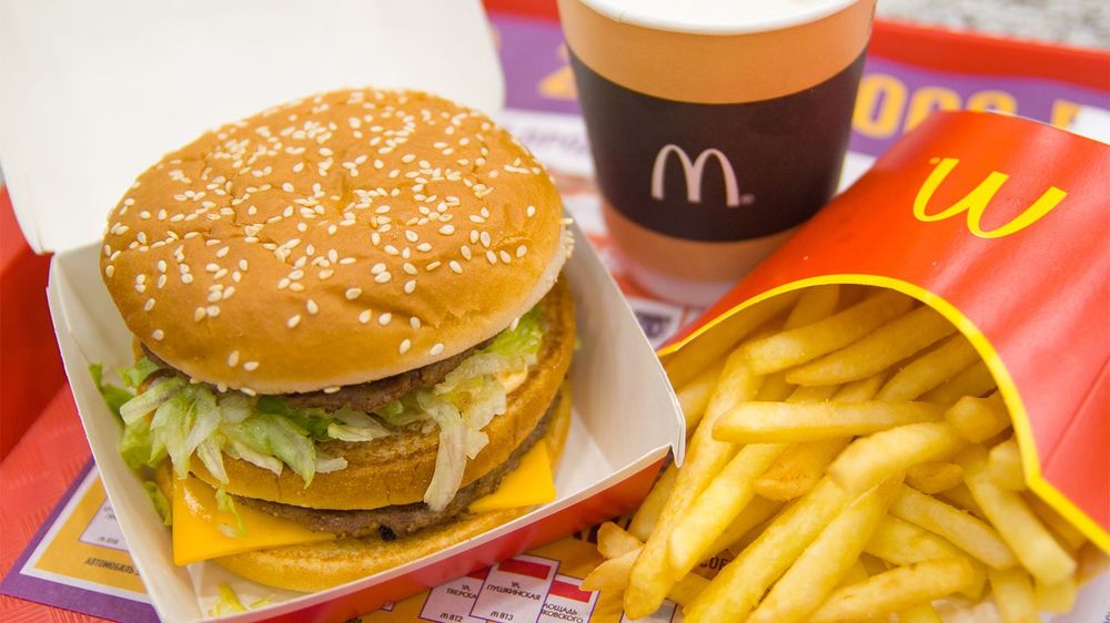Russia, Saint-Petersburg, December 24, 2018: Hamburger menu in McDonald's restaurant. Fries, coffee capuccino, Big Mac. Fastfood and junk food concept