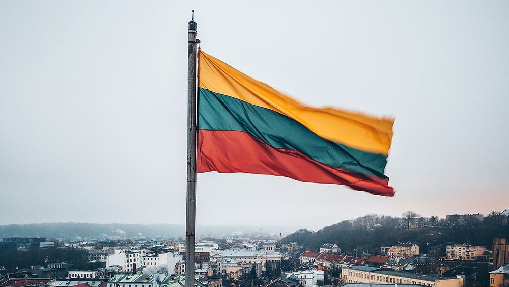 Lithuanian flag in the wind. Drone aerial view