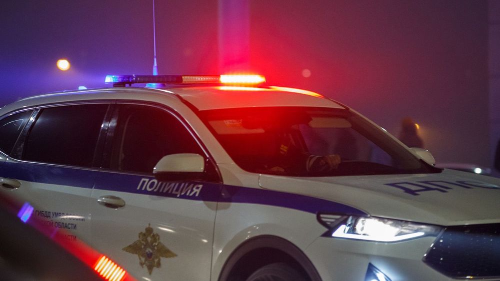 Tula, Russia - May 9, 2021: Road police car with turned on red and blue siren light on its roof on night city road