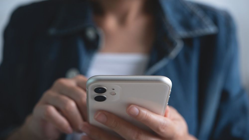 Close up of young asian woman hands holding and using mobile sma