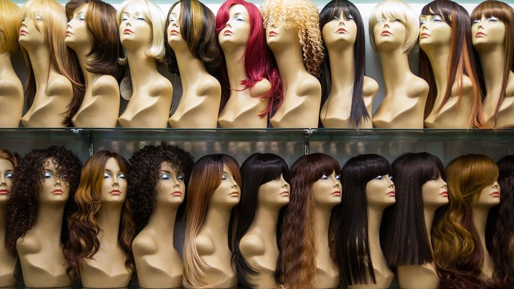 rows of mannequins ina wig shop