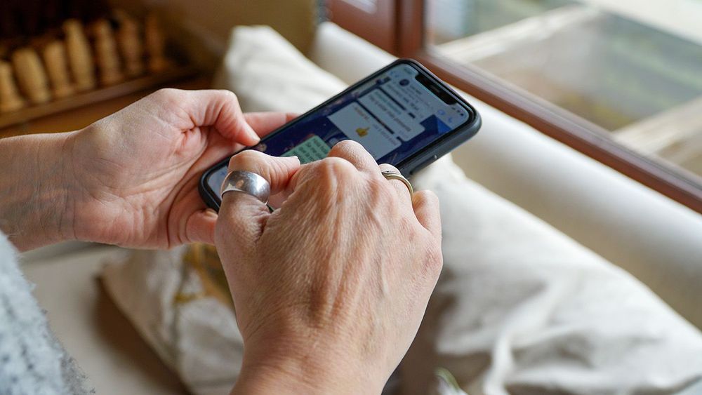 Close-up: Woman Typing on Phone Indoors