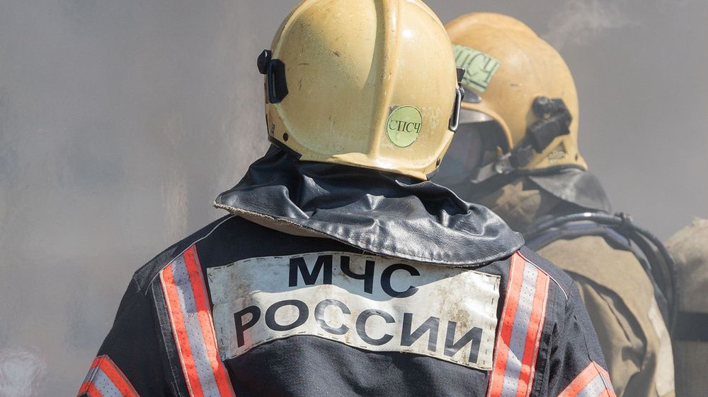 Back view with emblem Emercom of Russia on uniform firefighters of Ministry of Civil Defence, Emergencies and Disaster Relief of Russian MChS