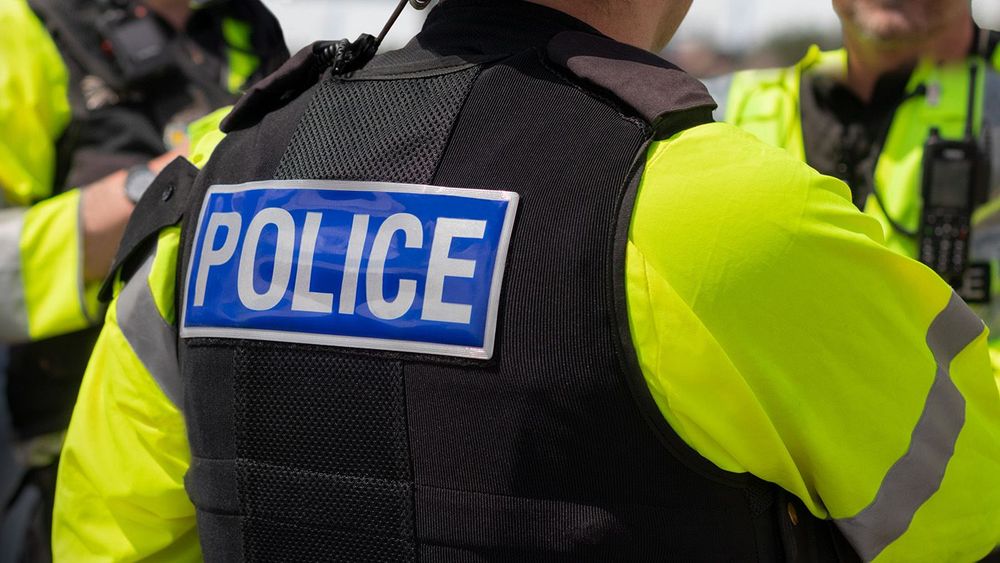 Police - Close-up of 'POLICE' marking on the back of a hi-visibi