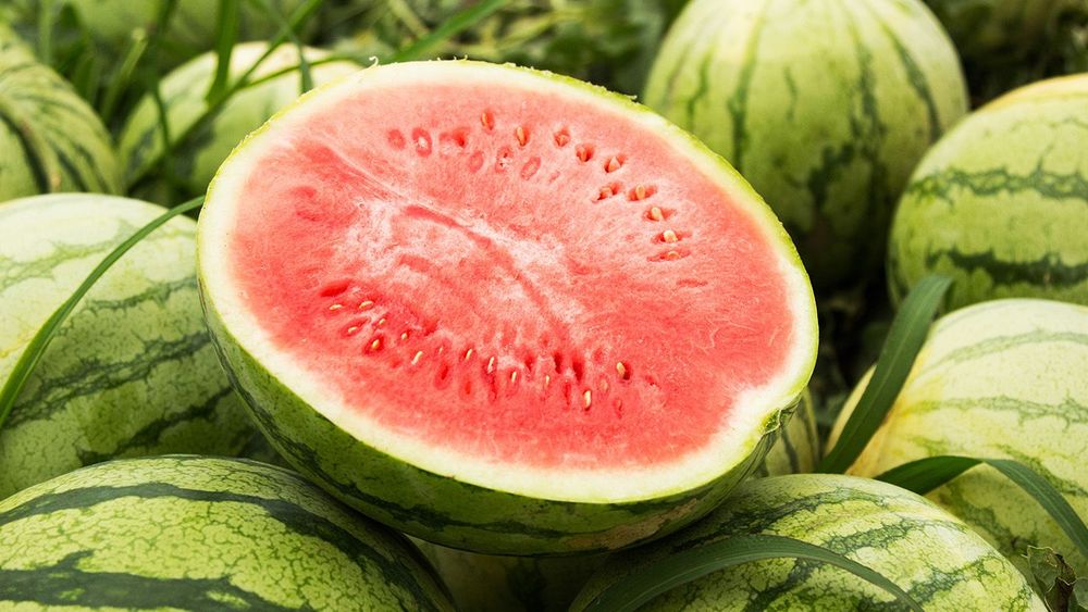 Half a red watermelon pitted, close-up.