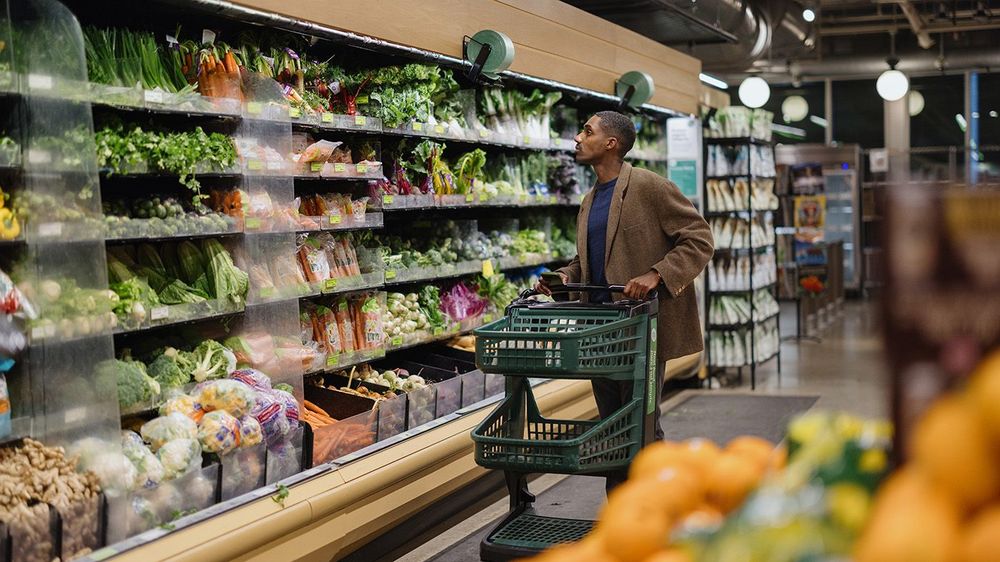 Man Shopping For Fresh Produce In a Grocery Store Aisle