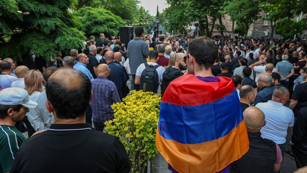 A Protestor wrapped in an Armenian flag seen during a