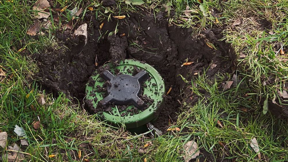 Anti-personnel mine in the ground. dig mine. antipersonnel mine. mining. Demining. Minefield