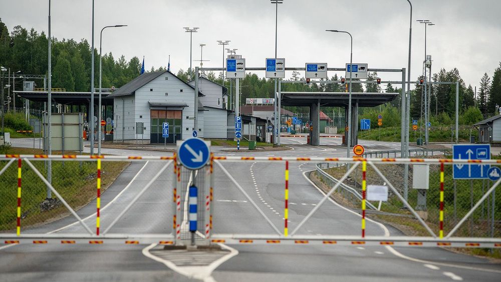 Finnish Border Guard at the barrier fence between Finland and Russia