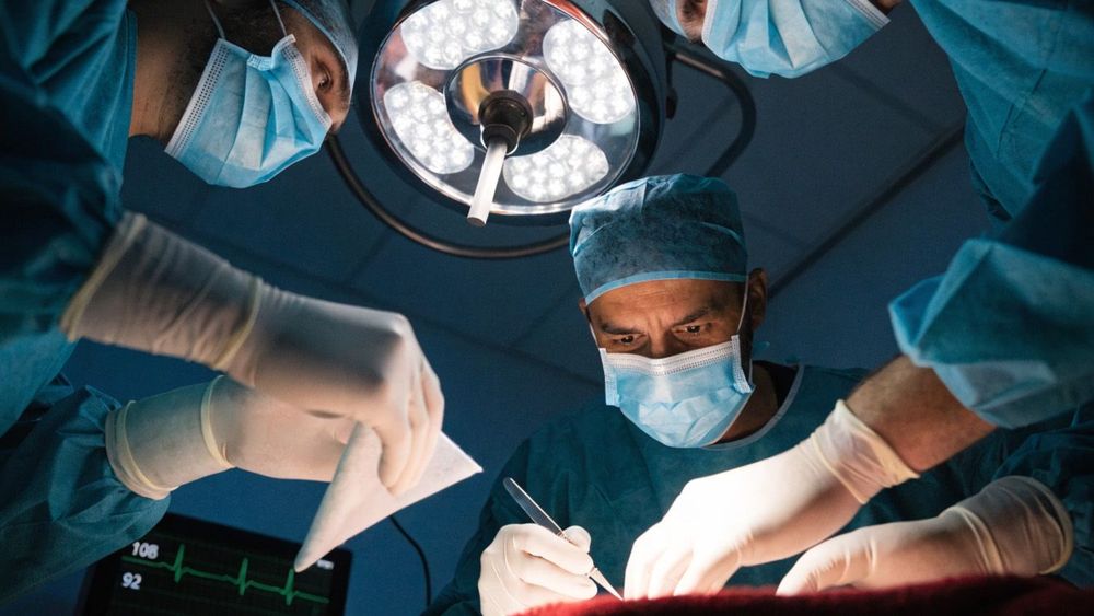 three-surgeons-in-dark-teal-scrub-gowns--matching-